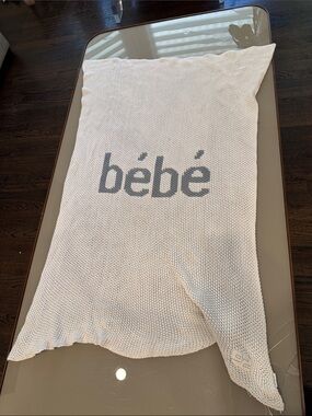 bebe cream knit throw with gray logo